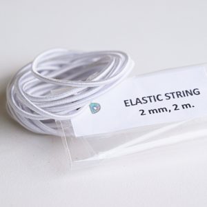Elastic cord for stringing dolls.
